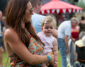 Lingfest 2019 Lady in summer dress holding toddler ©Brett Butler